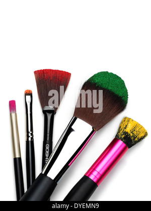 MakeUp Brushes with coloured powders on tips cut out on white with shadow Stock Photo