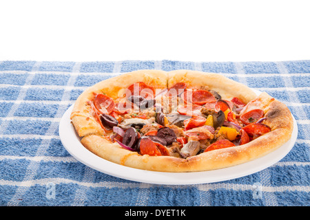 A single serve deluxe pizza on a white plate Stock Photo