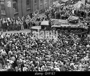 Crowds of people and a guard of honour of tanks, meeting M. Maisky, Soviet ambassador, and members of the Russian military mission when they arrived at a tank factory somewhere in Great Britain, where the week's tank production is for Russia, showing the 'Stalin' tank, which had just been christened by Madame Maisky 1942 Stock Photo