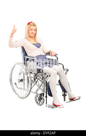 Disabled woman in a wheelchair giving thumb up Stock Photo