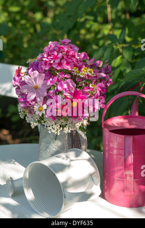 Summer flowers in a watering can Stock Photo