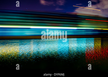 A slow shutter shot of a container ship passing by Savannah, Georgia late in the evening. Stock Photo
