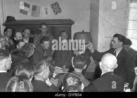 Employees of the East German State Railway during the ballot vote about the continuation of the strike in West Berlin; in the background there are the flags of the western allied occupying powers (France, USA and Great Britain) as well as the flag of Berlin with the bear, photograph taken on 02 June 1949. The whole railway operations and infrastructure of Berlin were subordinated to the East German State Railway (Deutsche Reichsbahn, DR) of the Soviet zone of occupation until 1949. On 21 May 1949, the Unabhängige Gewerkschaftsopposition UGO in the West sectors called upon to strike. Around 13. Stock Photo