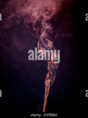 pink smoke against a dark blue background Stock Photo