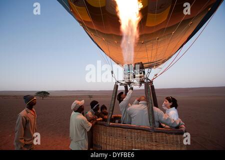 A hot air balloon is prepared at dawn for a ride across the sand dunes of Sossusvlei in Namibia, 15 January 2011. Photo: Tom Schulze -NO WIRE SERVICE – Stock Photo