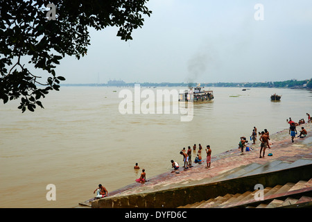 India, West Bengal, Kolkata, Calcutta, Ghat near Hooghly bridge, People bathing in Hooghly River Stock Photo