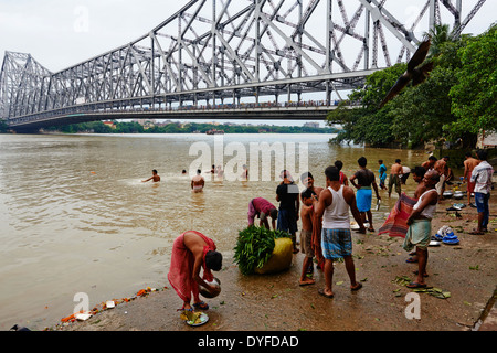 India, West Bengal, Kolkata, Calcutta, Ghat near Howrah bridge, People bathing in Hooghly River Stock Photo