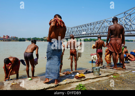 India, West Bengal, Kolkata, Calcutta, Ghat near Howrah bridge, People bathing in Hooghly River Stock Photo