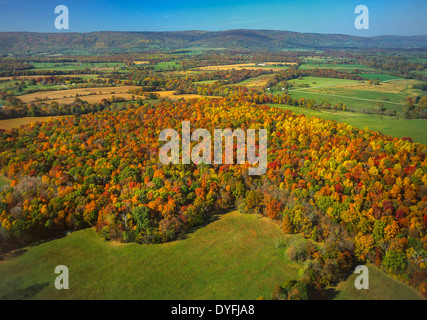 LOUDOUN COUNTY, VIRGINIA, USA - Aerial of farm land and fragmented forest, with Blue Ridge mountains in distance. Stock Photo