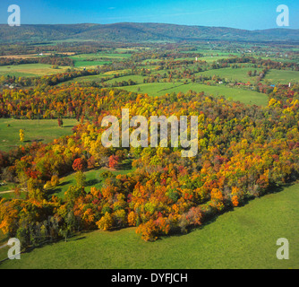 LOUDOUN COUNTY, VIRGINIA, USA - Aerial of fragmented forest with autumn foliage, with Blue Ridge mountains in distance. Stock Photo