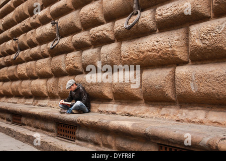 Young man reading a book in Florence, Italy Stock Photo