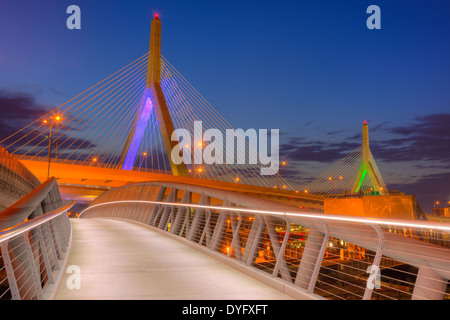 The North Bank Bridge for pedestrians and cyclists curves under the Leonard P. Zakim Bunker Hill Memorial Bridge in Boston, Mass Stock Photo