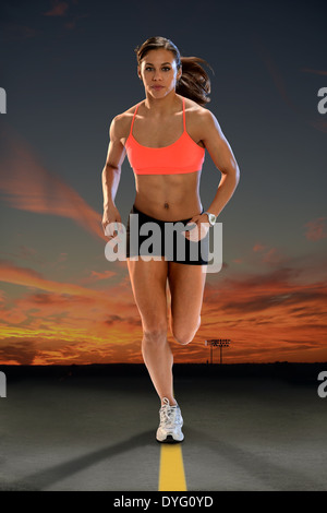 Young African American woman running at sunset Stock Photo