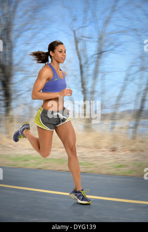 African American woman running outdoors Stock Photo