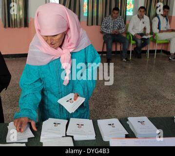 Algiers. 17th Apr, 2014. An Algerian woman collects her ballot at a polling centre in Algiers on April 17, 2014. Algerian voters started casting ballots Thursday morning in the country's presidential election, which pits incumbent President Abdelaziz Bouteflika against former Prime Minister Ali Benflis and four other candidates. Credit:  Mohamed Kadri/Xinhua/Alamy Live News Stock Photo