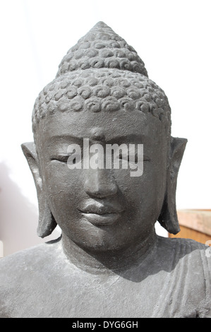 Buddha's head on a white wall background Stock Photo