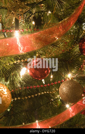 close up of Christmas Baubles on a illuminated Christmas tree Stock Photo