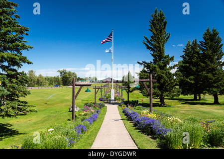 Flags and flower garden at the Glacier Park Lodge in East Glacier, Montana, USA. Stock Photo