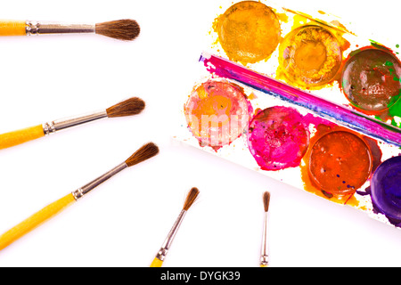 Set of used watercolour paints and paintbrushes on white Stock Photo