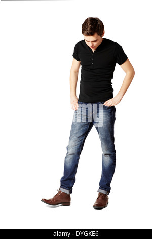 Young man watching his shoes. Studio shot. Stock Photo