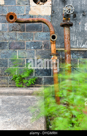 Rusty water pipes on wall, Falun, Falun Municipality, Dalarna County, Sweden Stock Photo