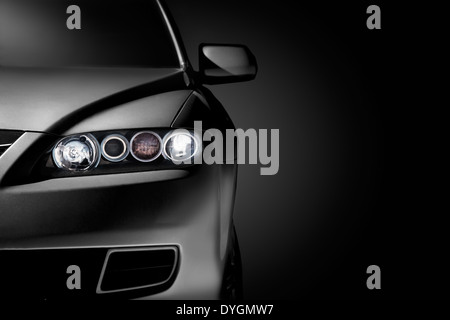 Gray modern car closeup on black background. Stock Photo