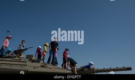Latrun, Jerusalem. 16th Apr, 2014. Visitors are seen on a Merkava Main Battle Tank IV at Yad La'shiryon Latrun, memorial site and the Armored Corps museum in Latrun, about 30 km west of Jerusalem, on April 16, 2014. As one of the most diverse armored vehicle museums in the world, Yad La'shiryon Latrun displays an array of over 150 armored vehicles. During the holiday of the Passover, an important Biblically-derived Jewish festival from April 14 to April 21 this year, museums across Israel are free for visiting. © Li Rui/Xinhua/Alamy Live News Stock Photo