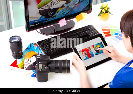 Photo editor working on computer and used graphics tablet. Stock Photo