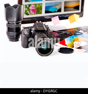 Photography concept. Digital camera, monitor and photos on white background. Stock Photo