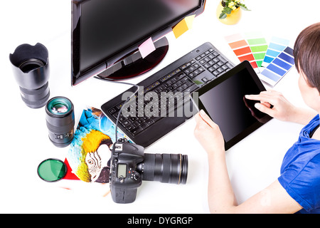 Photo editor working on computer and used graphics tablet. Stock Photo