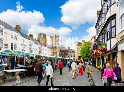 Market stalls in the Market Place with the Cathedral and Bishop's Palace behind, Wells, Somerset, England, UK Stock Photo