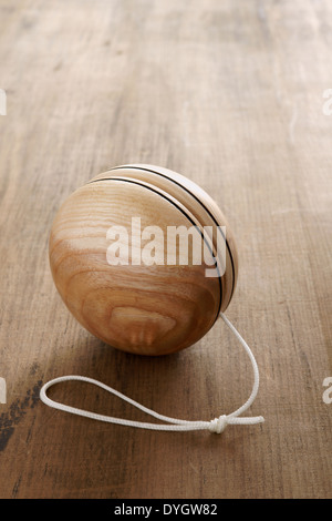An old fashioned style wooden yoyo a retro childhood concept Stock Photo