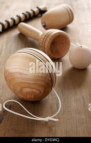 Old fashioned wooden toys. Yo yo, cup and ball and a top and whip a retro childhood concept Stock Photo