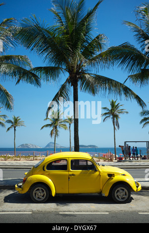 RIO DE JANEIRO, BRAZIL - FEBRUARY 6, 2014: Old yellow Volkswagen Type 1 Beetle, known locally as a Fusca, parked in front of Ipa Stock Photo
