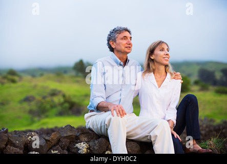 Mature middle age couple in love watching the sunset Stock Photo