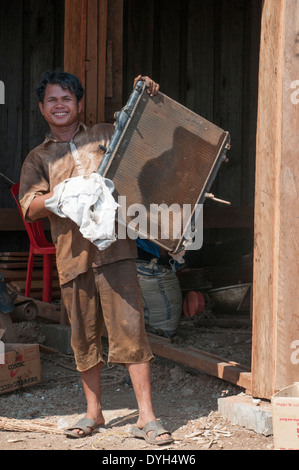 Mechanic at a roadside garage in rural Mondulkiri province, Cambodia Stock Photo