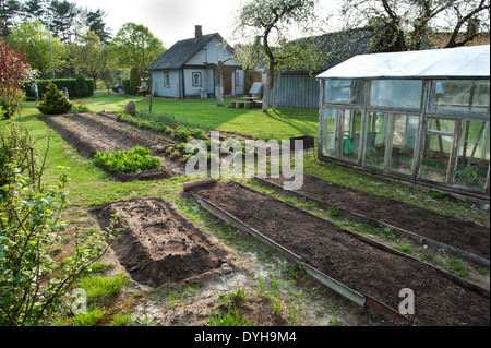 An allotment garden in Lithuania, with a small wooden house, known as a sodyba. Stock Photo