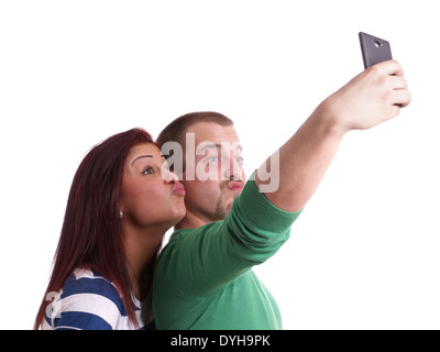 silly young couple making duck face while taking selfie with smart phone camera Stock Photo