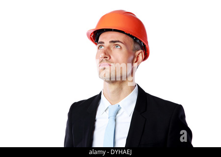 Portrait of a confident businessman in helmet looking up over white background Stock Photo
