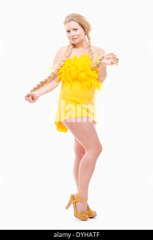 Easter - Young Woman with Long Blond Hair in Yellow Dress. Stock Photo