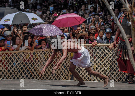 San Fernando, Philippines. 18th Apr, 2014. A penitent stumbles while taking part in a reenactment of Jesus Christ's crucifixion during Good Friday in San Fernando town, Pampanga province, Philippines, April 18, 2014. Crucifixions remain a common practice during Holy Week throughout the country despite being strongly condemned by the Roman Catholic church. Penitents who take part believe the act will atone them for their sins and give them blessings.Photo: Ezra Acayan/NurPhoto Credit:  Ezra Acayan/NurPhoto/ZUMAPRESS.com/Alamy Live News Stock Photo