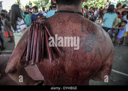 San Fernando, Philippines. 18th Apr, 2014. The bloodied back of a flagellant is seen during Good Friday in San Fernando town, Pampanga province, Philippines, April 18, 2014. Crucifixions remain a common practice during Holy Week throughout the country despite being strongly condemned by the Roman Catholic church. Penitents who take part believe the act will atone them for their sins and give them blessings.Photo: Ezra Acayan/NurPhoto Credit:  Ezra Acayan/NurPhoto/ZUMAPRESS.com/Alamy Live News Stock Photo