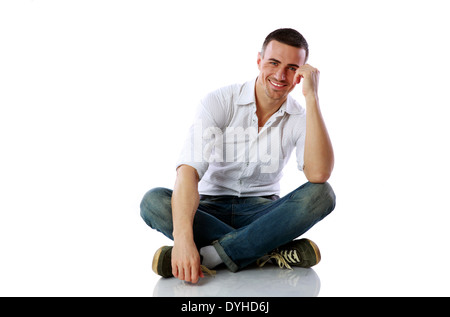 Handsome happy man sitting at the floor over white background Stock Photo