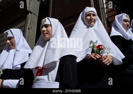 Jerusalem. 18th April 2014. Nuns stand at the entrance to the Alexander Nevsky Church as thousands of Christians partake in Processions of the Cross along the Via Dolorosa leading to the Church of the Holy Sepulchre on Good Friday. Easter celebrations, based on the Gregorian and Julian calendars, coincide this year uniting East and West in Jerusalem. Credit:  Nir Alon/Alamy Live News Stock Photo