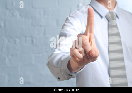 Businessman pushing imaginary button one finger - insert own concept Stock Photo