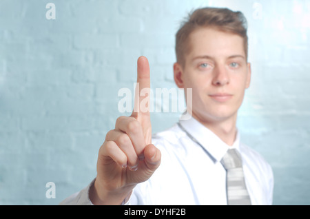 Businessman pushing imaginary button one finger - insert own concept Stock Photo