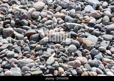 Pebbles and stones at the picturesque harbour at Cove Bay, Aberdeen city, Scotland, UK Stock Photo