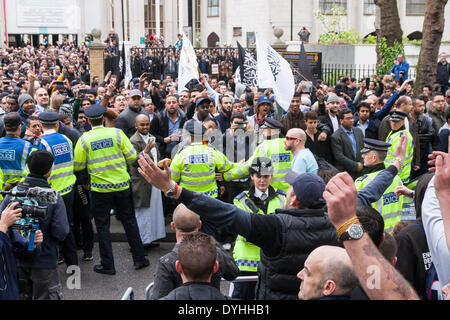 London, April 18th 2014. The EDL in the foreground and other British right wing anti-Islamists counter-demonstrate Anjem Choudary and his Islam4UK group protesting , against 'Cameron's crusades', as hundreds of Muslims leave after Friday prayers at Regent's Park Mosque. Credit:  Paul Davey/Alamy Live News Stock Photo