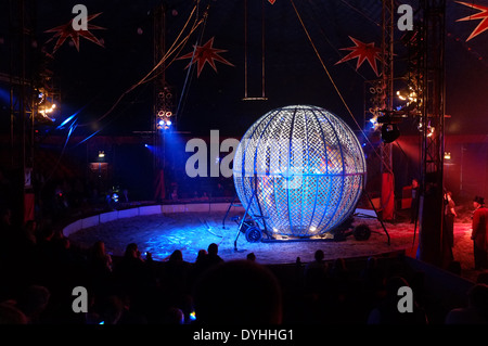 Two motorbikes inside a steel cage during a circus show performing loops inside the cage. The circus was travelling through Bannockburn in Scotland Stock Photo