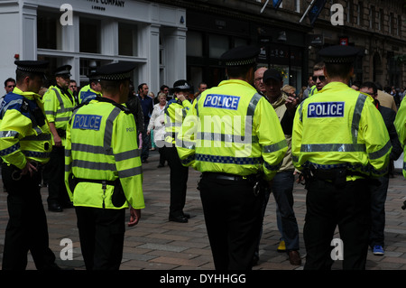 Police lined up during a demonstration on the busy street of Queen Street, Glasgow. BNP were handing out leaflets. Stock Photo